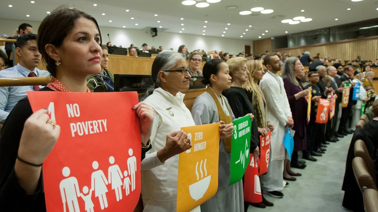 People holding Sustainable Development Goal placards at a civil society gathering